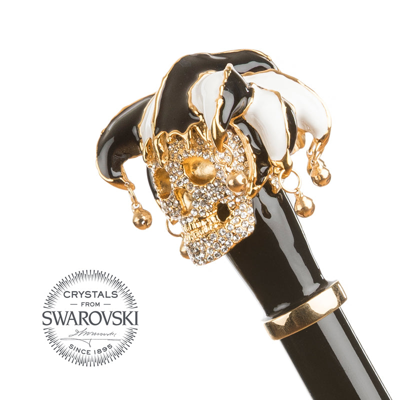 Jester skull handle set with Swarovski crystals above a gold-tone collar and glossy black grip, Crystals from Swarovski seal