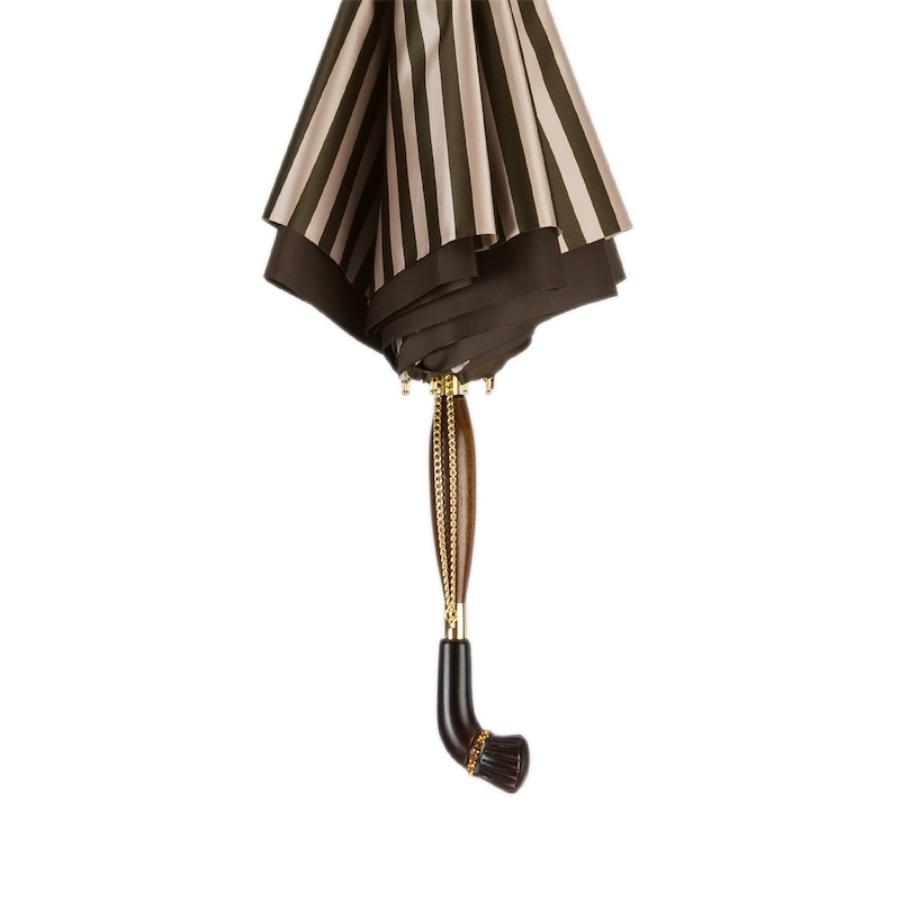 Furled umbrella held upside down, showing the brown inner layer and the wooden handle