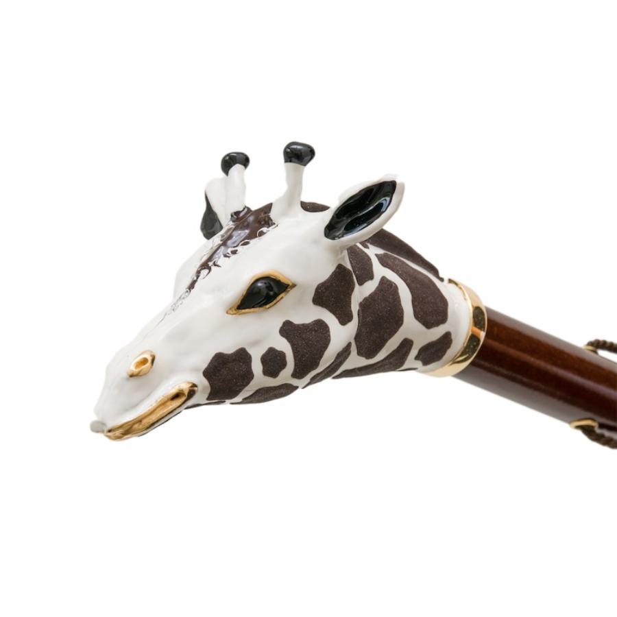 Enameled giraffe head with gold-tone eyes and mouth and black-tipped horns, close-up