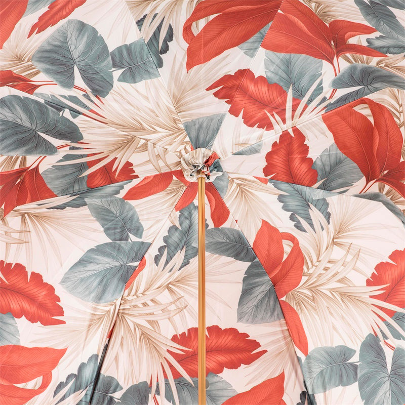 Inside of the canopy: red, slate grey and beige tropical leaves on a cream ground