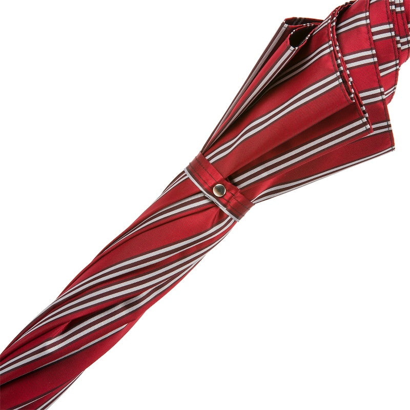 Striped strap with silver-tone snap button on the furled canopy