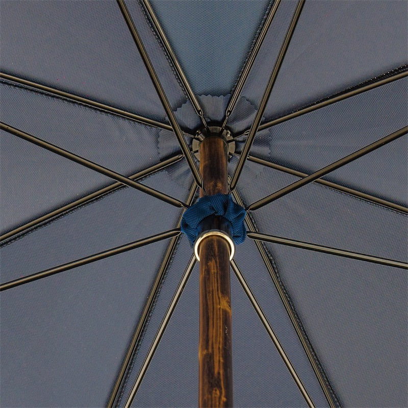 Underside of the navy canopy: eight ribs and the wooden shaft