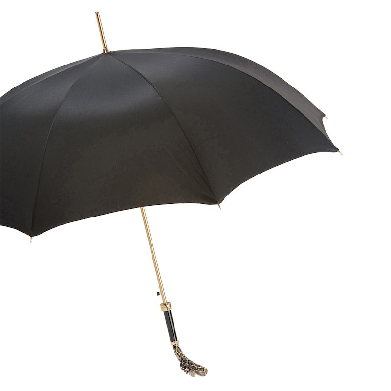 Open black umbrella from the side with gold-tone shaft and tarantula handle