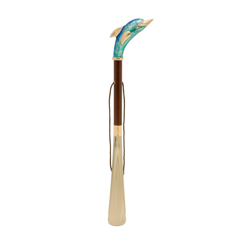 Dolphin shoehorn standing upright: dark brown wooden shaft, hanging cord and gold-tone blade