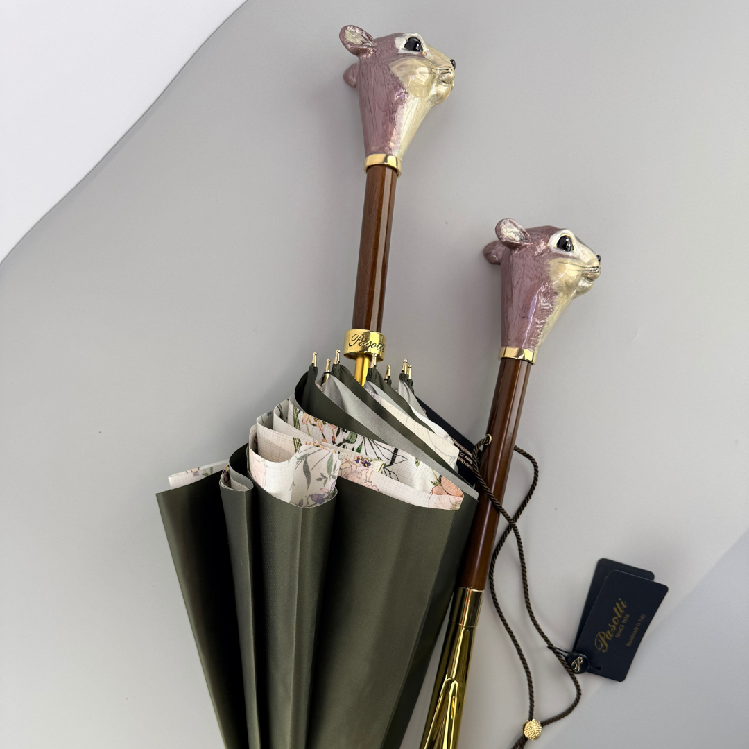 Squirrel head shoehorn shown next to a Pasotti umbrella with a matching squirrel handle