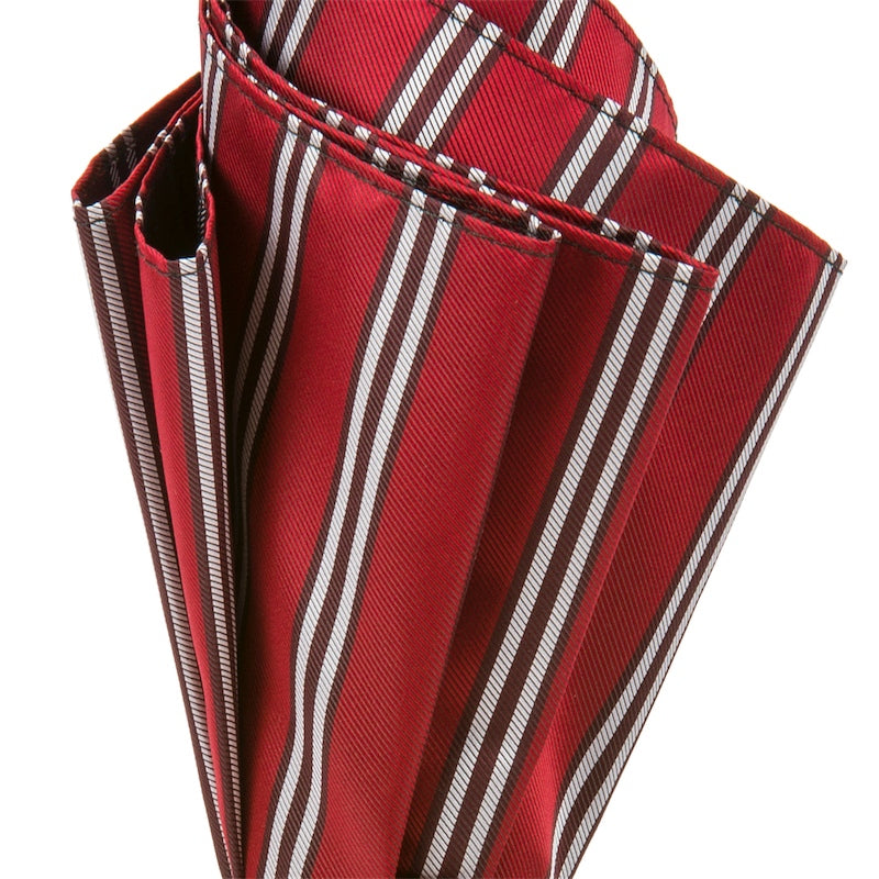 Folds of the red canopy with white and burgundy stripes, close-up