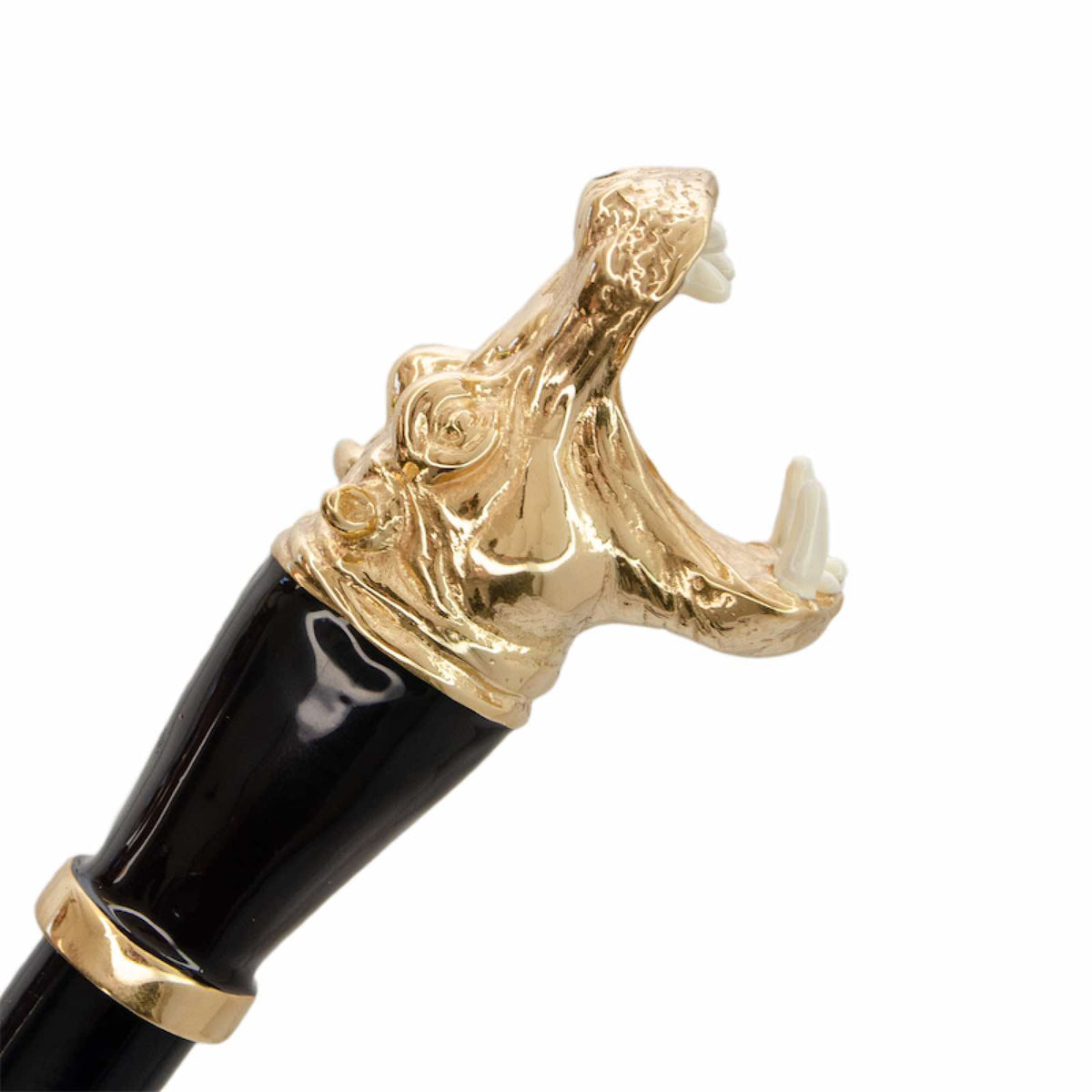 Gold-tone hippo head with an open mouth and white tusks, side close-up, handcrafted in Italy