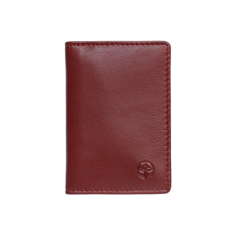 Tony Perotti Cortina 5004 rosso — the red leather business card holder closed, with the embossed compass rose on the front