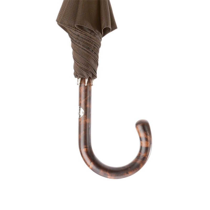 Mottled hickory crook handle below the furled brown canopy
