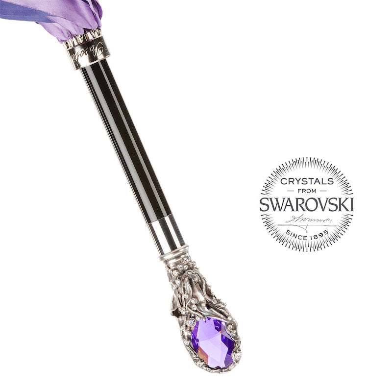 Glossy black grip with an engraved silver-tone Pasotti collar above the crystal handle