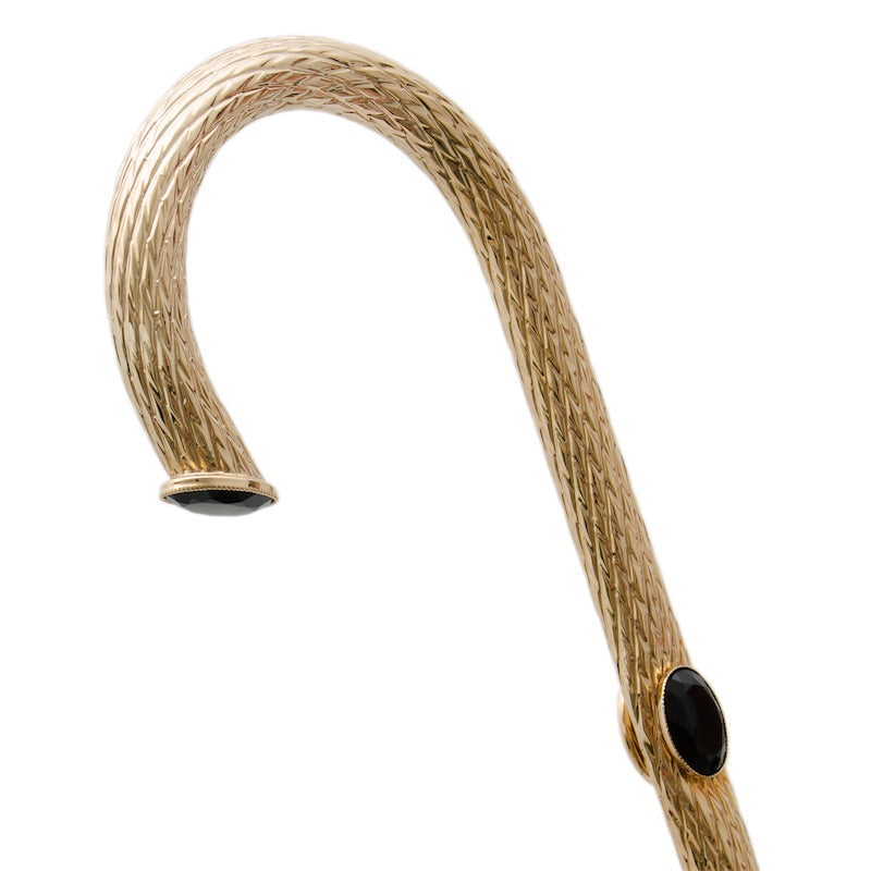 Gold-tone brass crook handle with fine diamond-pattern knurling and black oval rhinestones, close-up, handcrafted in Italy