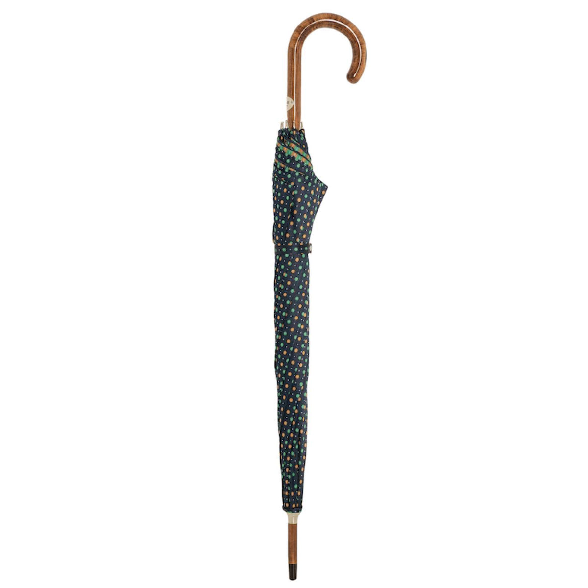 Closed navy floral umbrella standing upright with maple crook handle