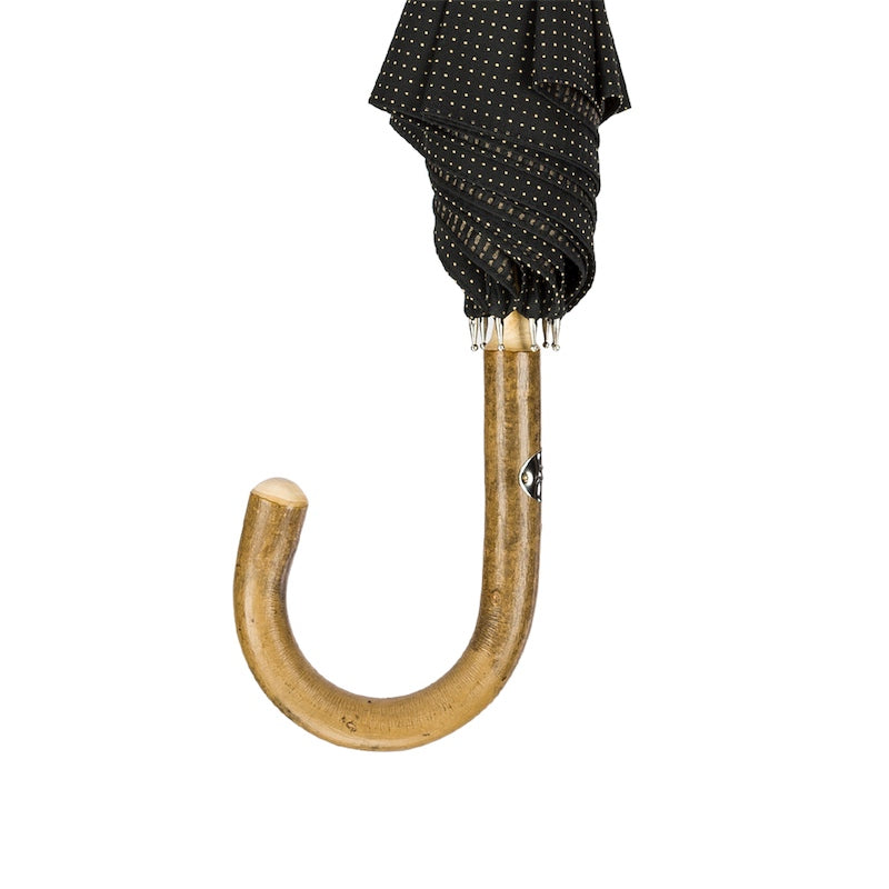 One-piece ash crook handle hanging below the furled umbrella