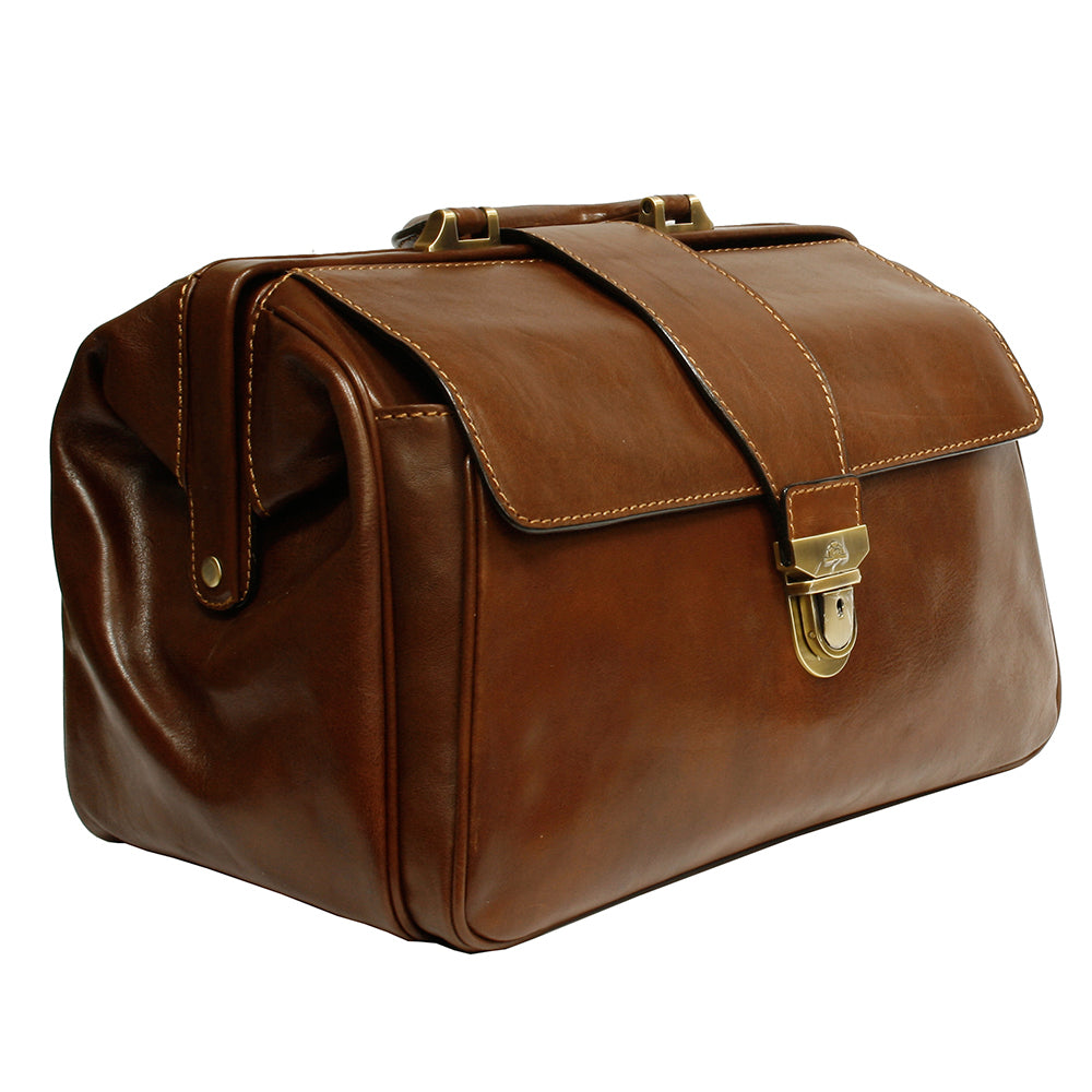 Angled view of the cognac Italico 8051 doctor bag — deep gusset with snap tab and clasp lock with keyhole
