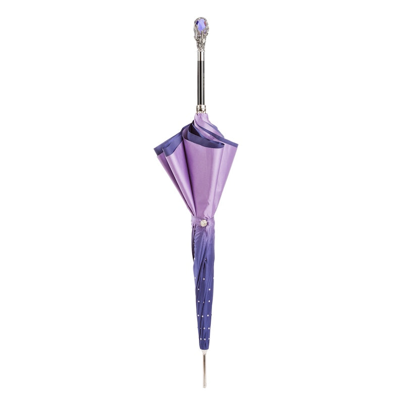 Closed purple umbrella standing upright with the jewel-like handle on top