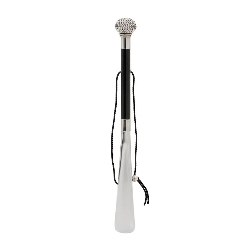 Crystal knob shoehorn standing upright: glossy black shaft, hanging cord and silver-tone blade