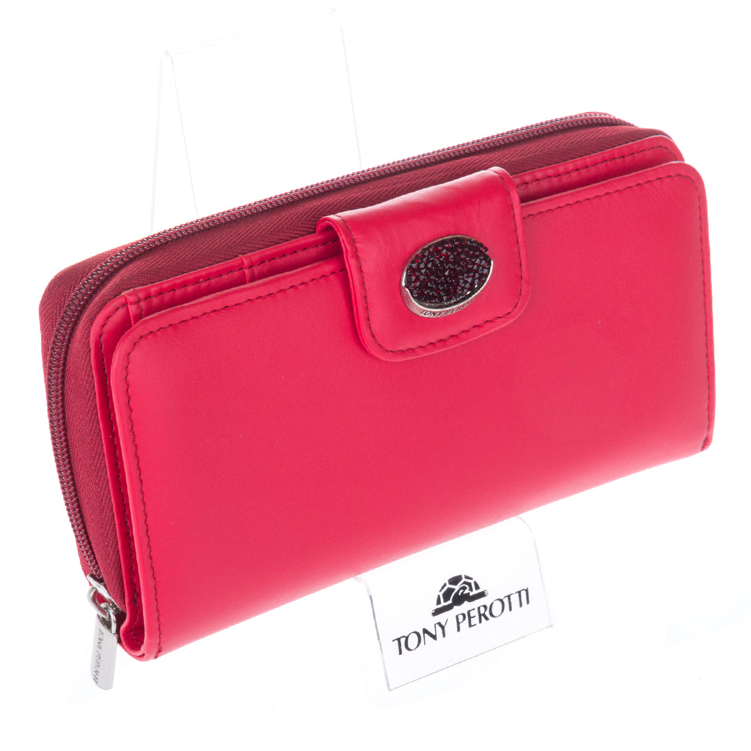 Red Swarovski wallet on display stand with Tony Perotti counter card