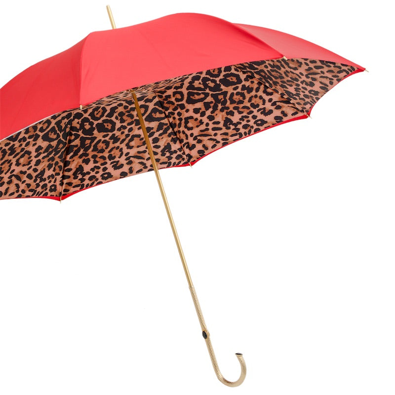 Open umbrella from the side: red outer canopy, leopard print inside and gold-tone shaft
