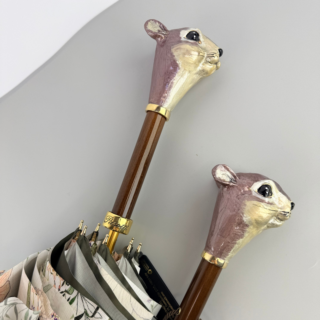 Two matching squirrel head handles side by side: on the shoehorn and on a Pasotti umbrella, close-up