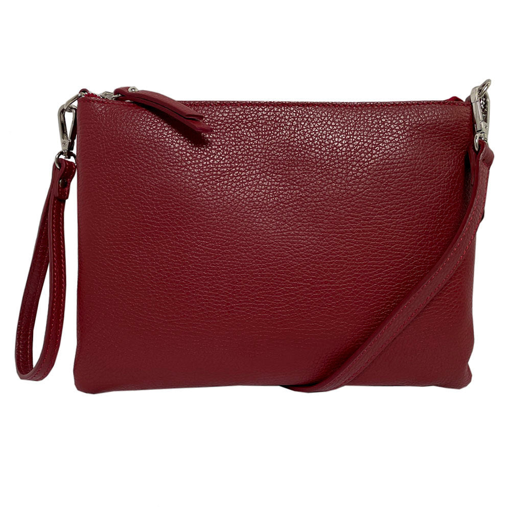 Red Tony Perotti Borsa CA046 leather clutch bag seen straight on — both straps attached, the wrist strap on the left and the shoulder strap on the right