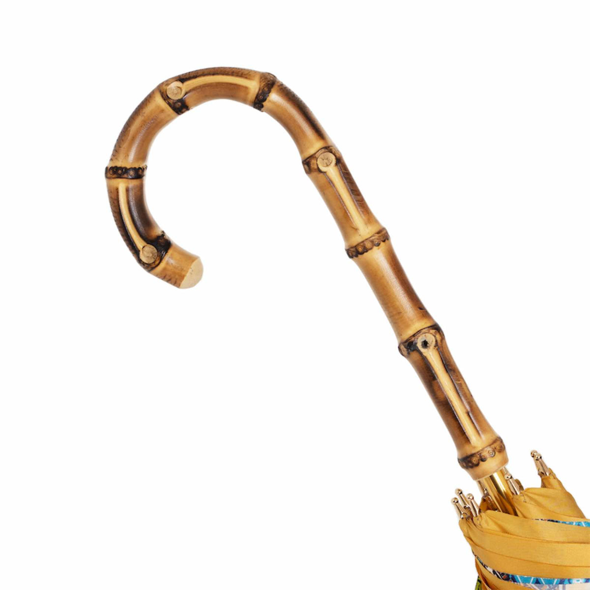 Bamboo crook handle with natural nodes above the furled canopy, close-up, handcrafted in Italy