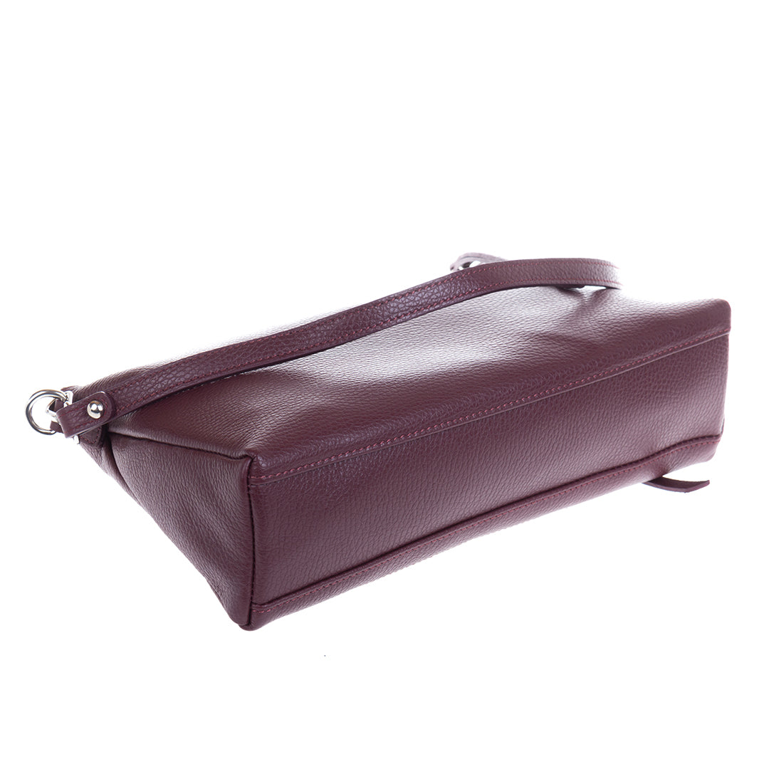 Tony Perotti Borsa CA01A-18BO burgundy leather bag tipped to show the flat base and the seams along the bottom