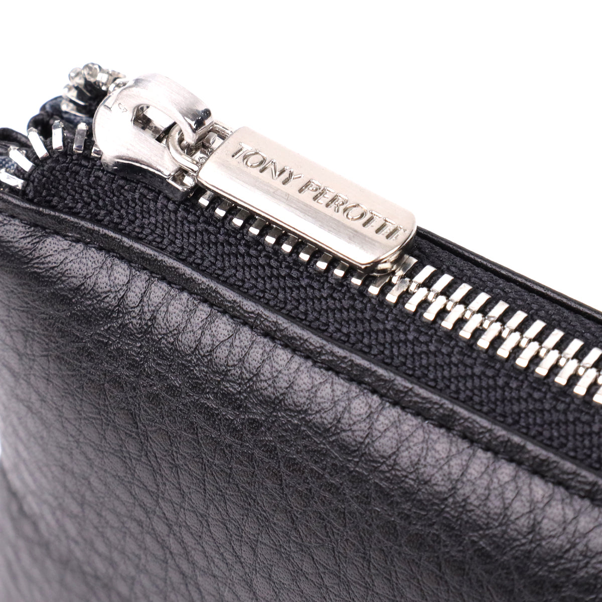 Close-up of the TONY PEROTTI engraved zip pull on the New Contatto 2651 nero