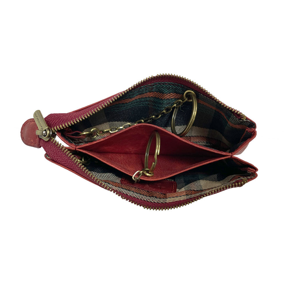 Red Arno 3350 key case open — two zip compartments with tartan-check lining, a leather divider and the two brass key rings on chains