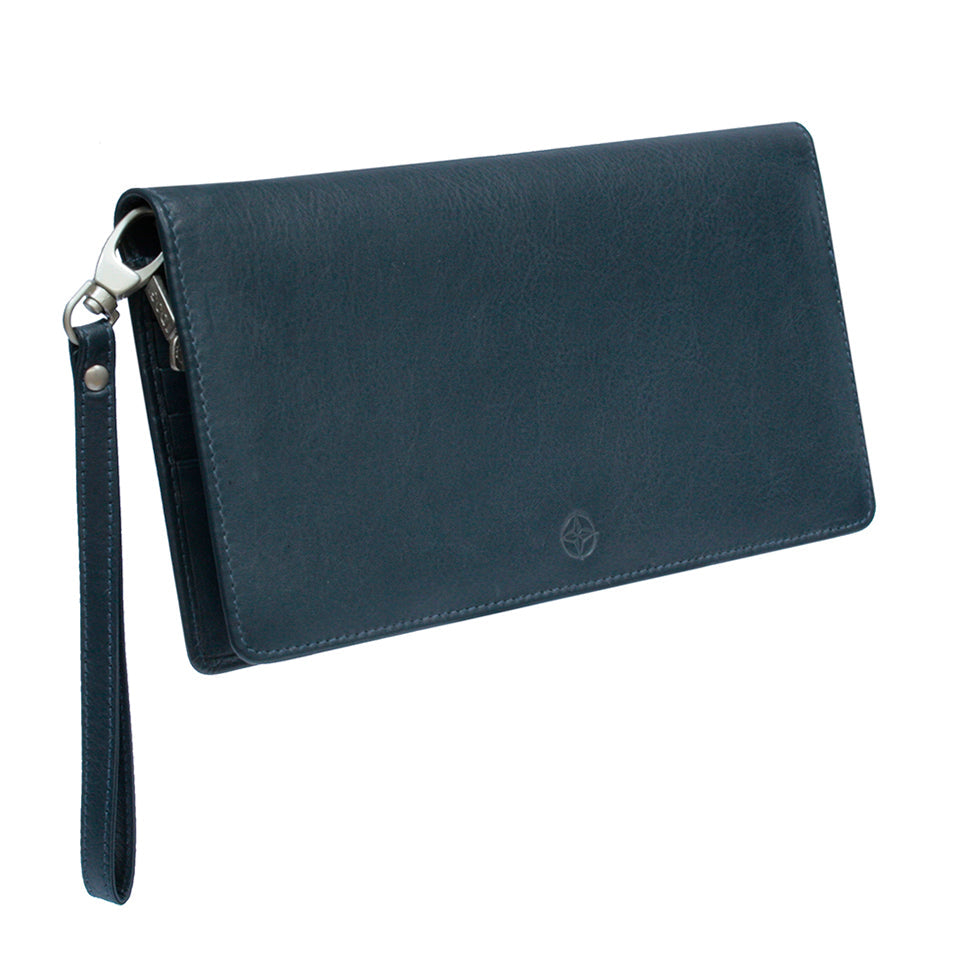 Tony Perotti Cortina 5067 navy dark blue leather clutch wallet closed at an angle — flap front with the embossed compass rose and the detachable leather wrist strap on a dark silver snap hook