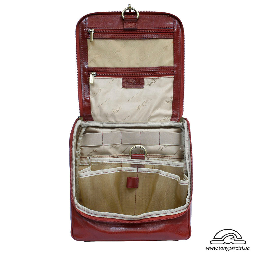 Open Tony Perotti Italico 8220 rosso toiletry bag showing zip pockets, elastic holders and beige lining