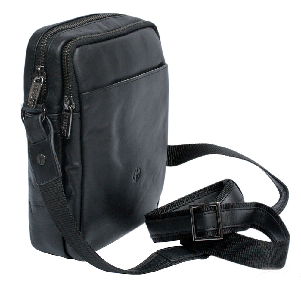 Black Tony Perotti Cortina 6049 leather crossbody bag at an angle — two zip compartments, front slip pocket and the webbing strap with its metal buckle