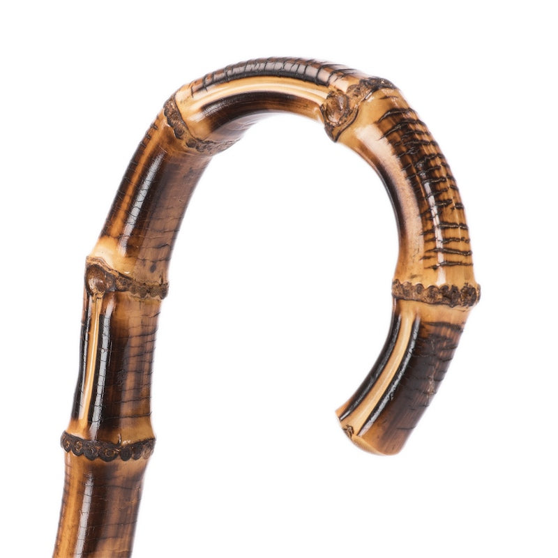 Bamboo crook handle with natural nodes and toasted markings, close-up, handcrafted in Italy
