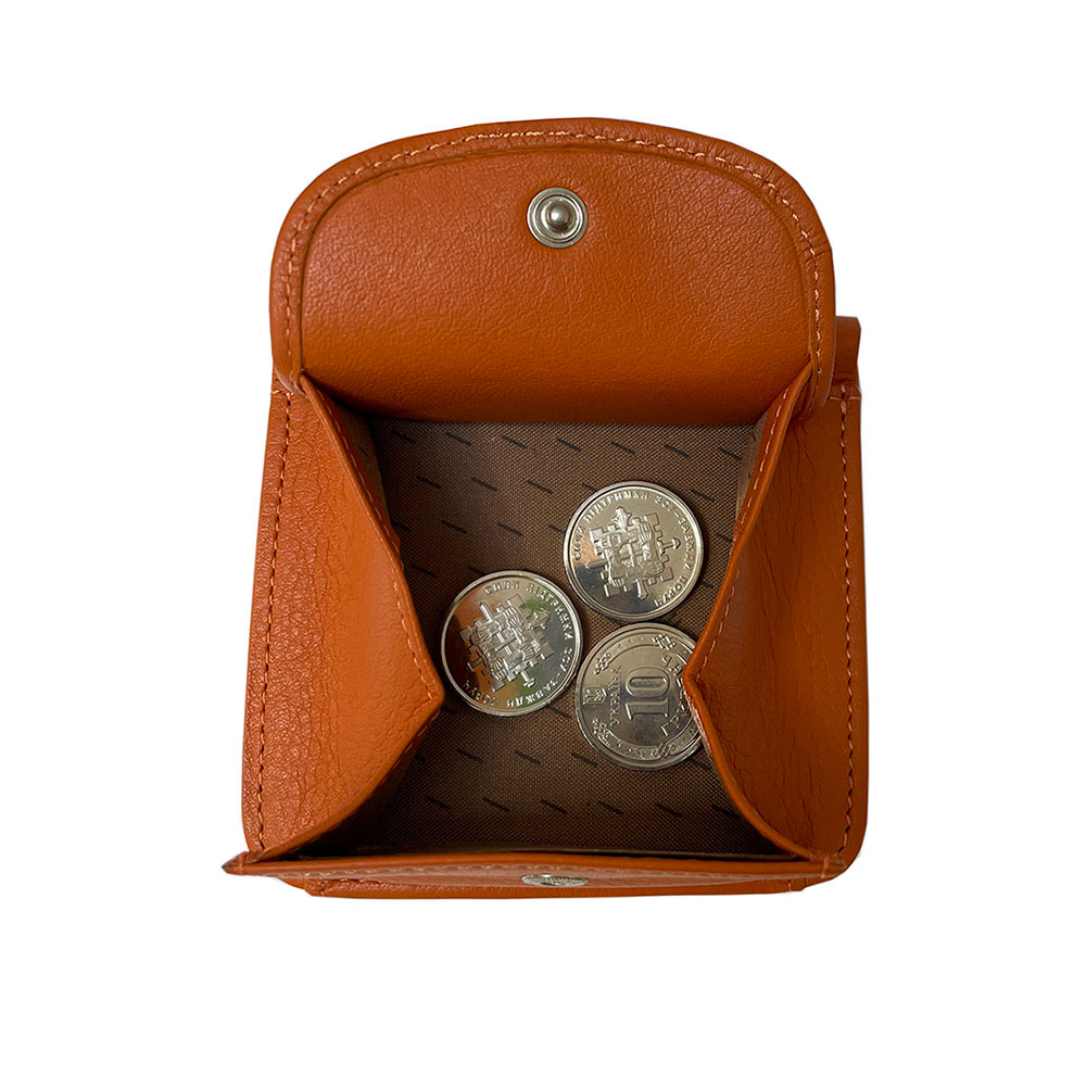 Open fold-out coin pocket of Tony Perotti orange leather wallet with coins