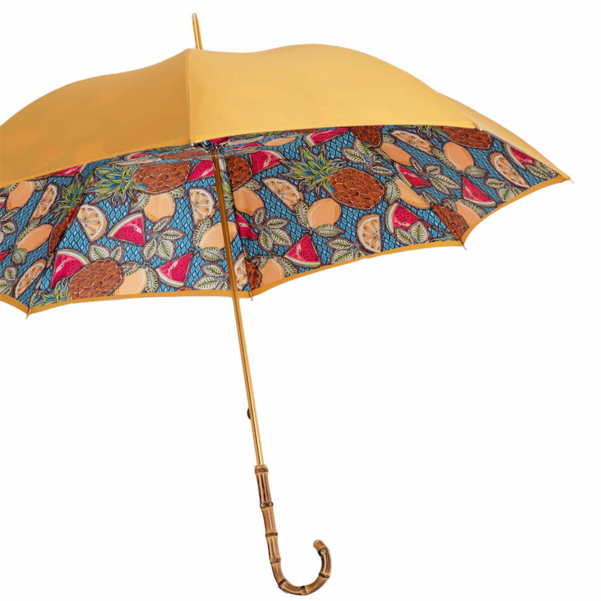 Open umbrella from the side: mustard yellow outer canopy, fruit print inside and bamboo handle
