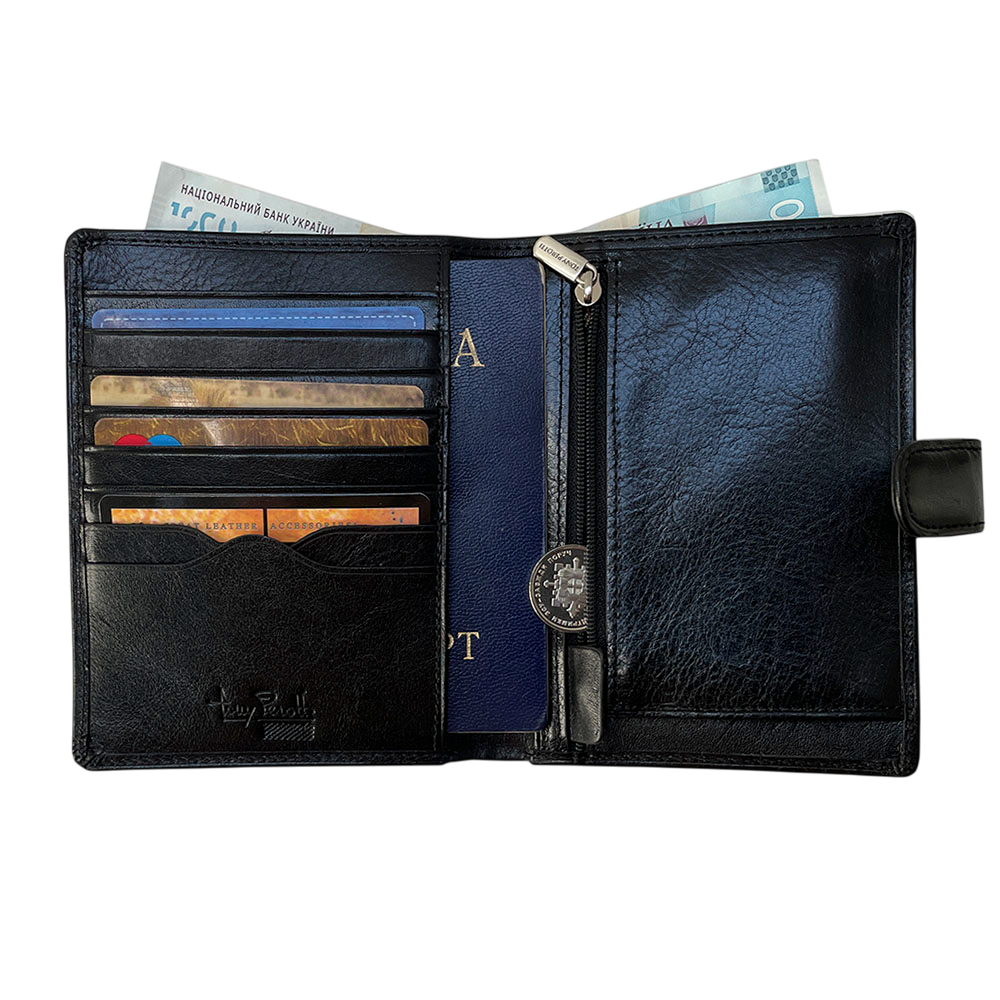 Tony Perotti Italico 3274A nero passport wallet opened with cards, a passport in the transparent sleeve, banknotes and a coin in the zip pocket