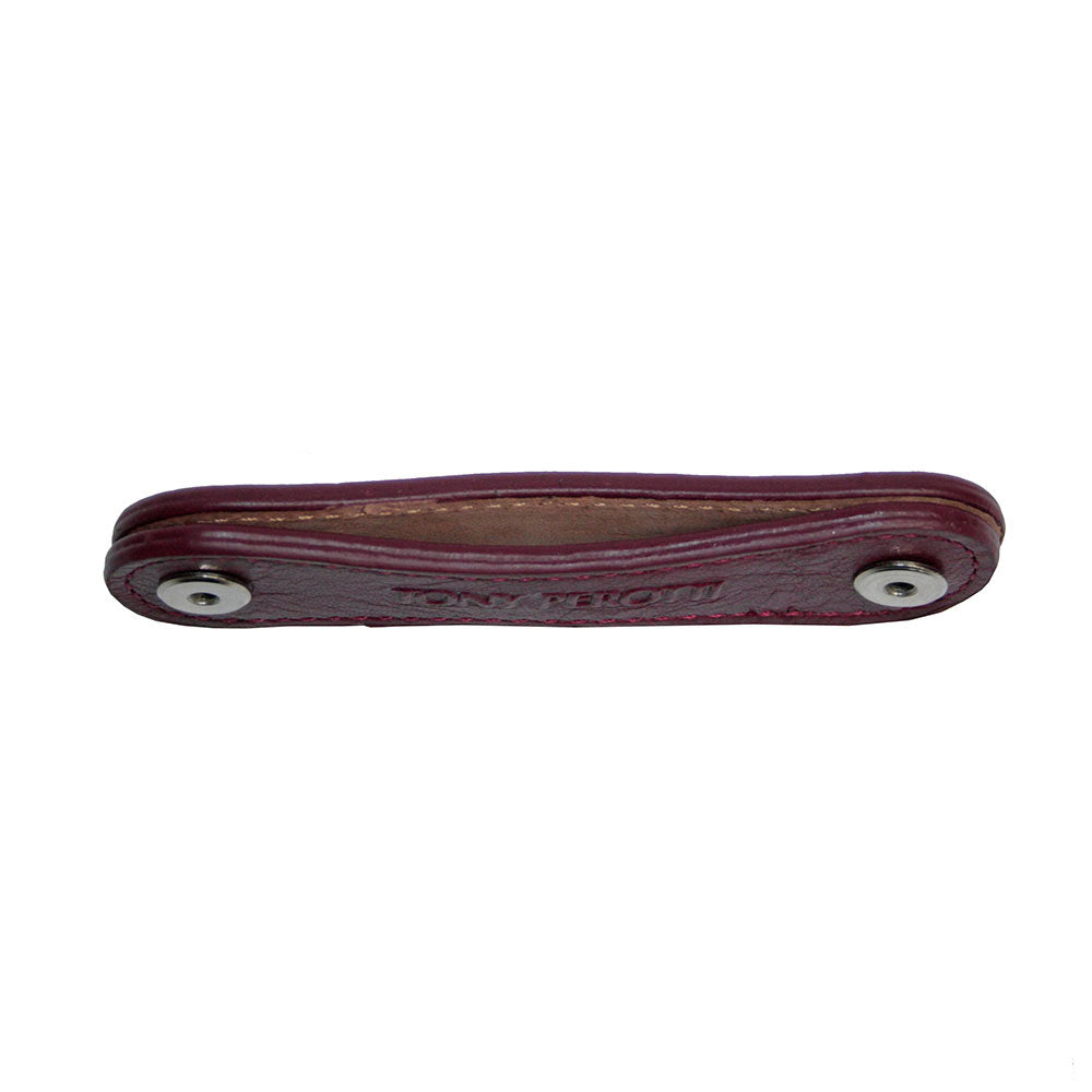 Tony Perotti Nevada KR-198 rosso — seen edge-on: the folded strap with a post at either end and the natural undyed reverse inside