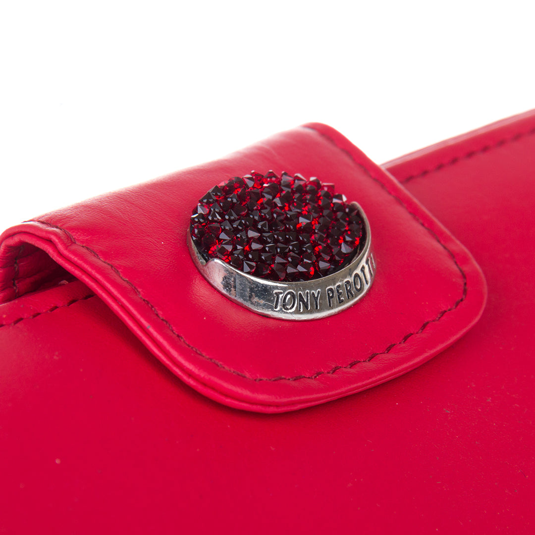 Close-up of the oval medallion paved with deep-red Swarovski crystals and engraved Tony Perotti