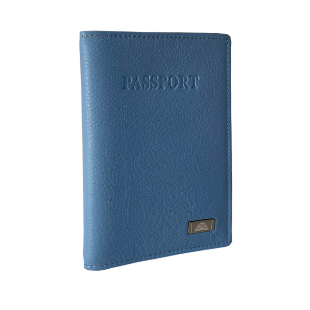 Angled view of the light blue Tony Perotti Contatto 2241 baby passport cover showing the fine pebbled grain and the silver-tone logo plate