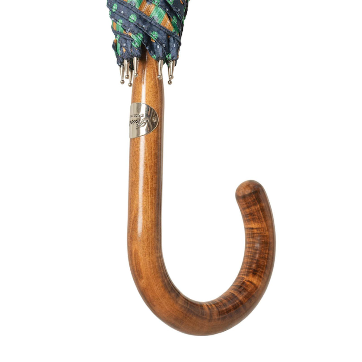 Glossy maple crook handle below the furled canopy