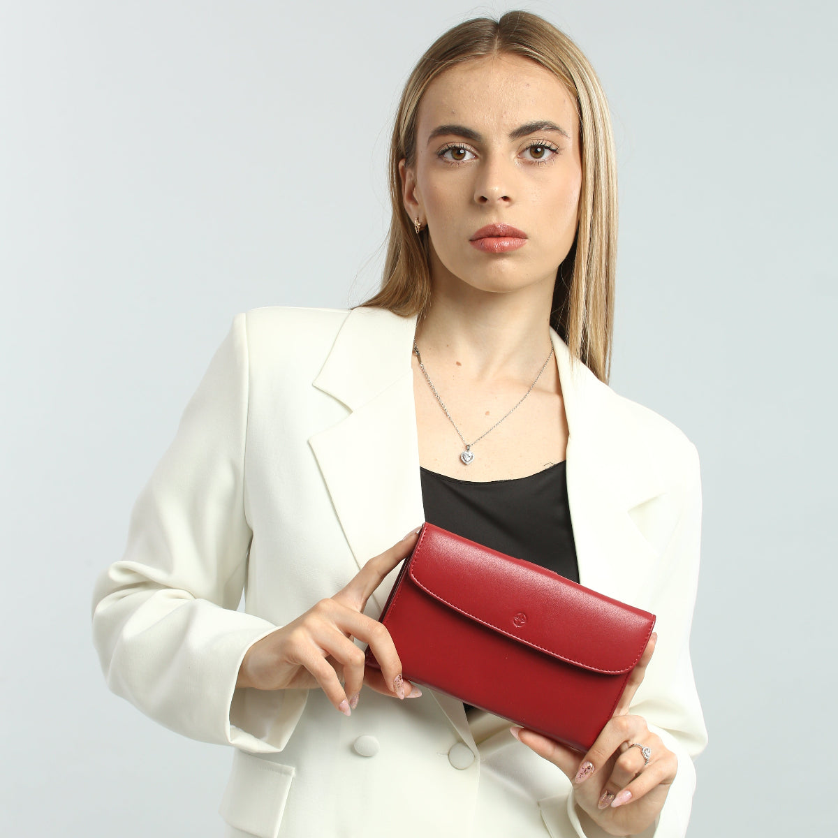 Model holding the closed red Tony Perotti Cortina 5073 wallet at chest height