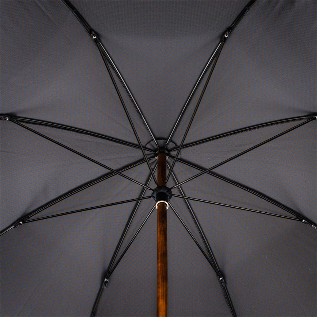 Underside of the dark canopy with eight ribs and maple shaft