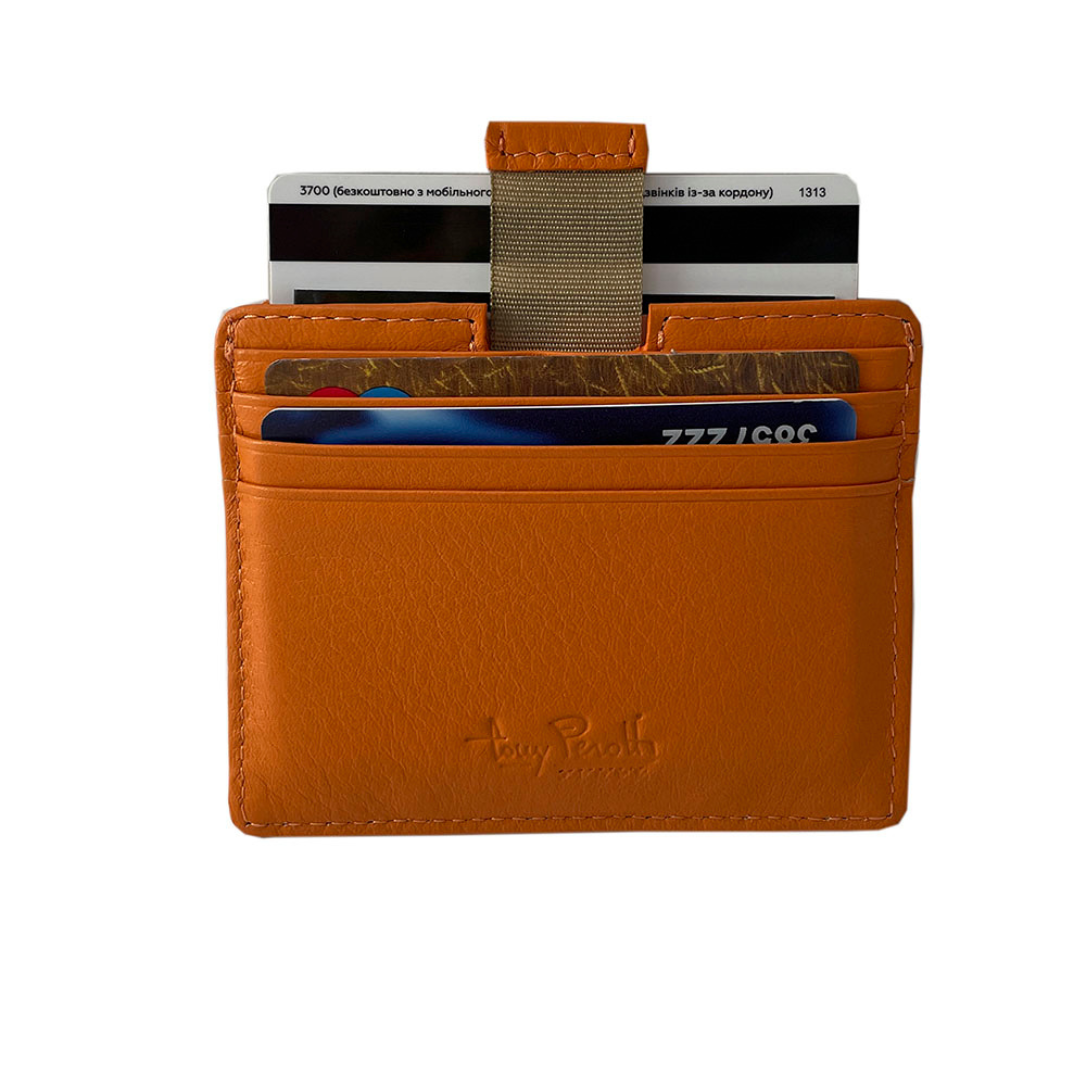 Close-up of the leather tab and woven pull strap that lifts the contents of the central compartment of the Tony Perotti Contatto 2236N arancio card holder